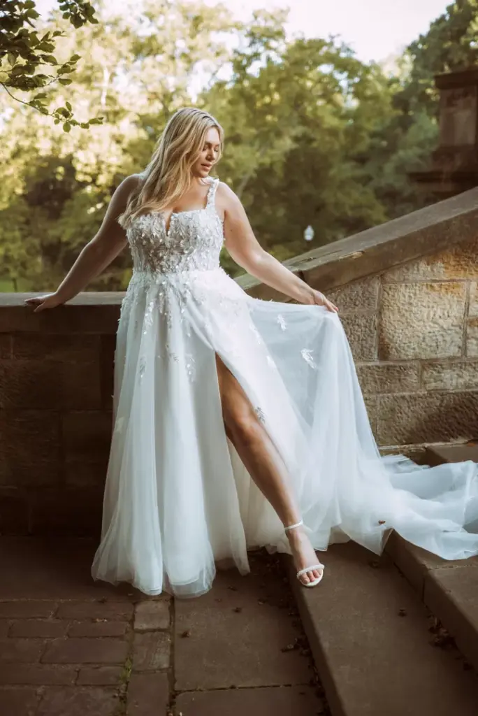 Brautkleid mit Spitzenoberteil, schmalen Trägern und hohem Beinschlitz